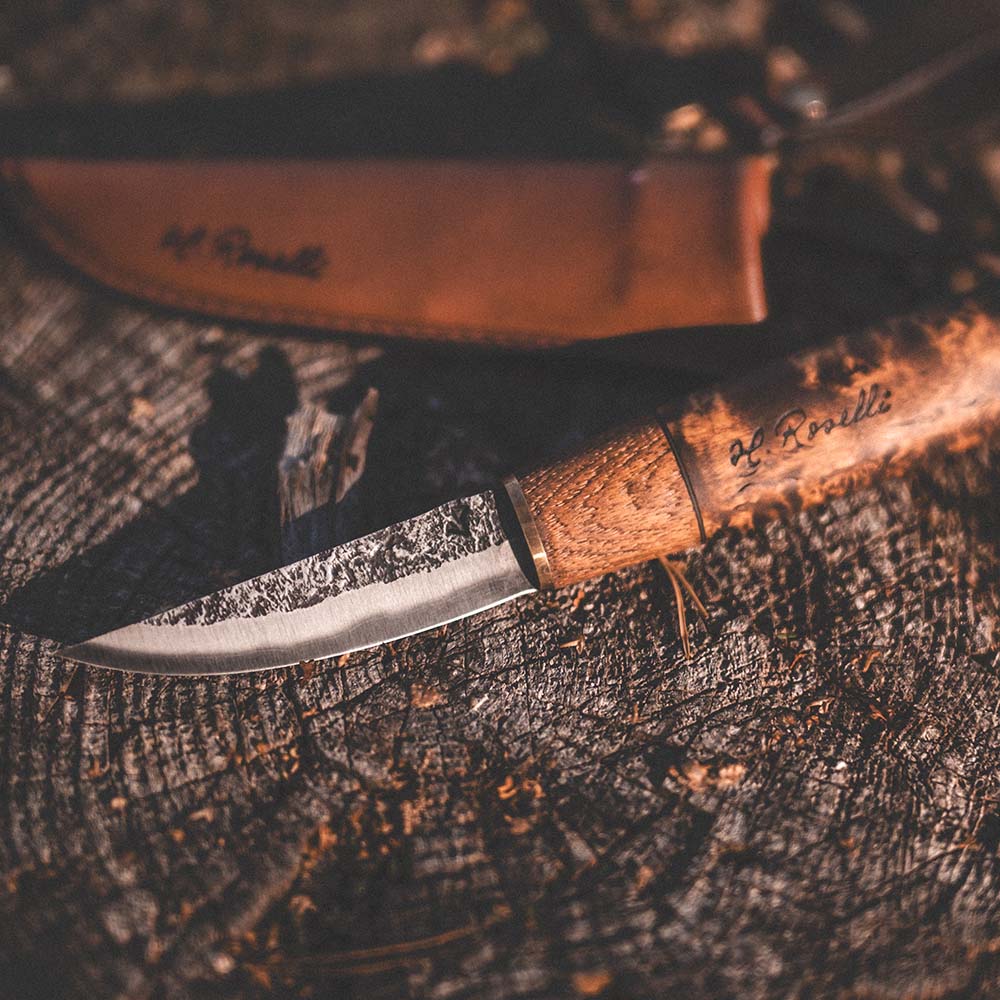 Roselli's handmade Finnish outdoor knife made of carbon steel and a handle of curly birch. Comes with a handmade sheath  made from Finnish leather.