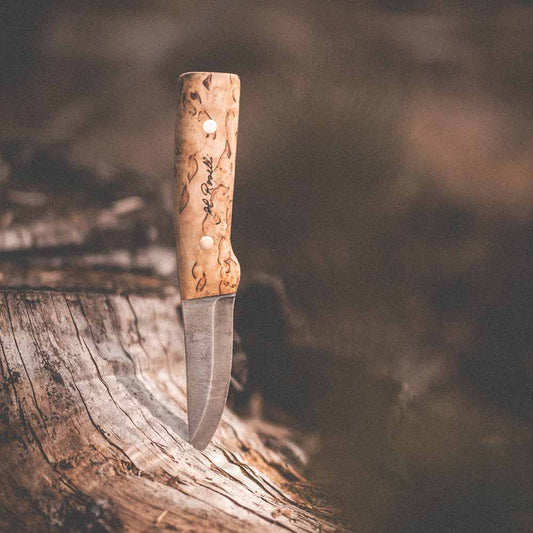 Handmade Finnish hunting knife with a full tang blade and a handle made out of curly birch and a sheath made out of light tanned leather sheath